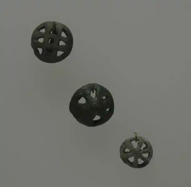 Bronze disc with holes that form a cross